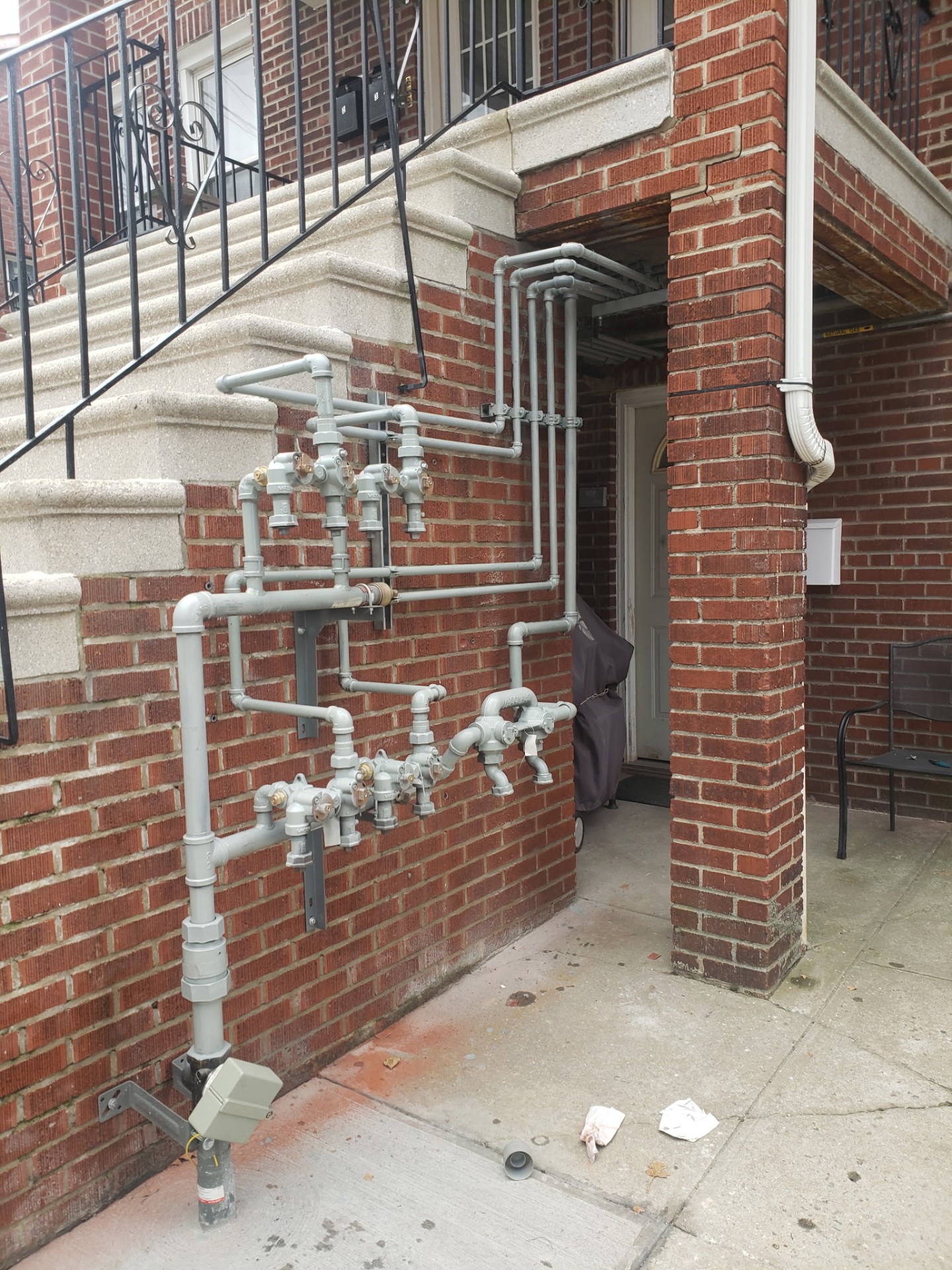 Gas pipe installation on brick wall