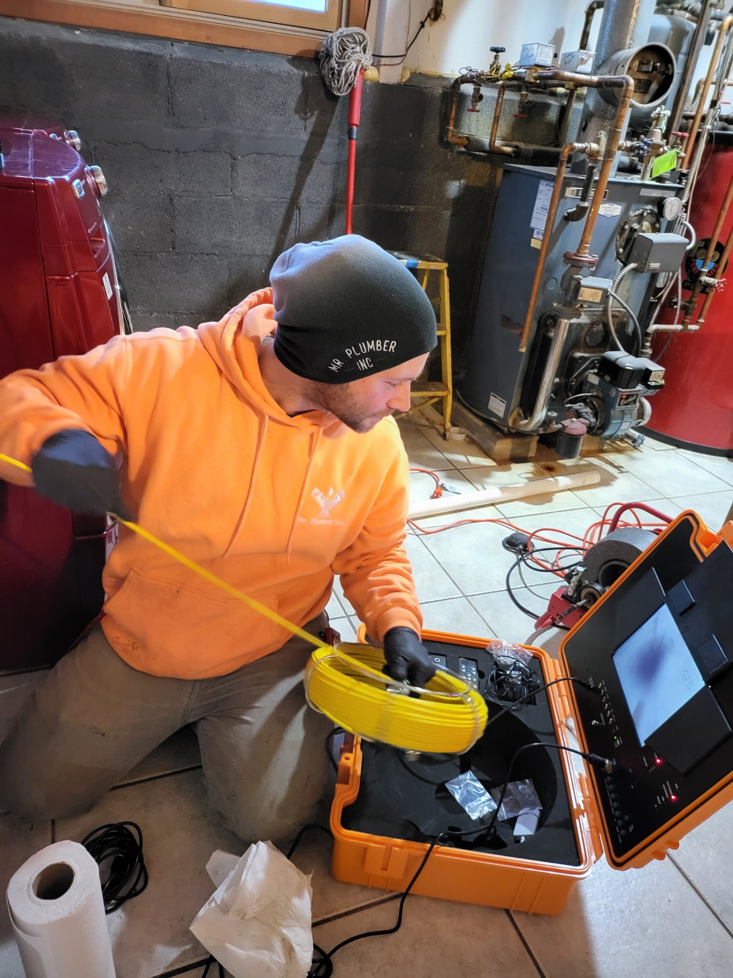 Technician using sewer camera equipment