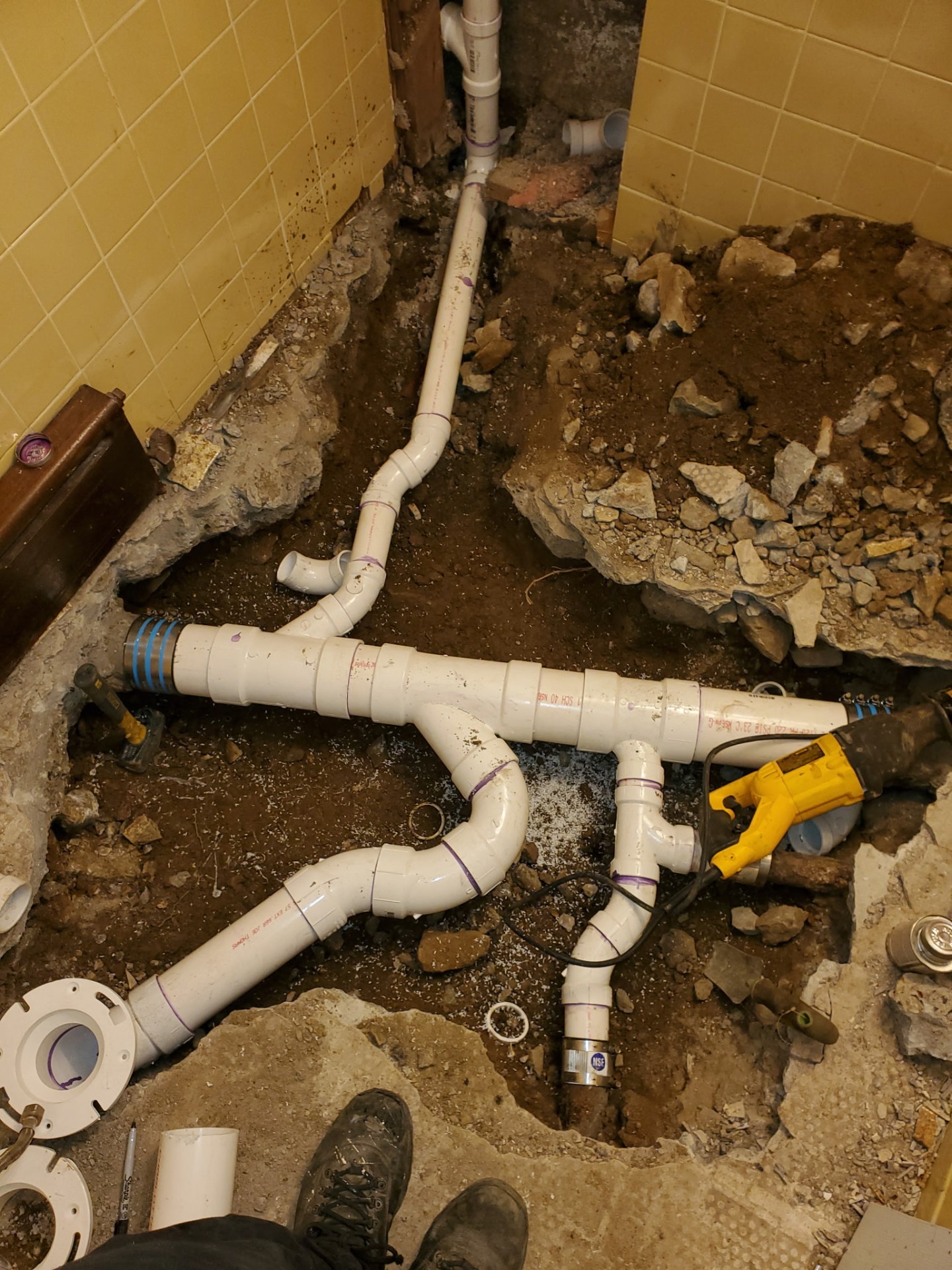 Pipe replacement work on bathroom floor